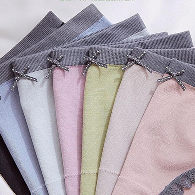 Las bragas al por mayor de la ropa interior atan las bragas del bikini para mujeres inconsútiles de la ropa interior del algodón de la cintura de las mujeres las mediados de